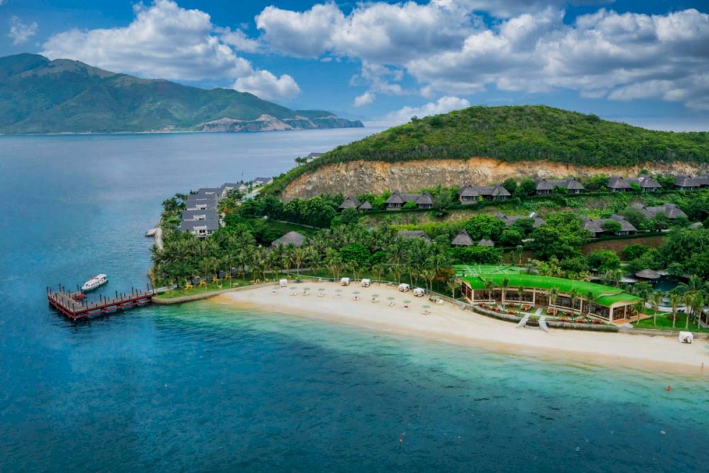 Dam Bay features soft white sand and shallow turquoise water, ideal for swimming and kayaking